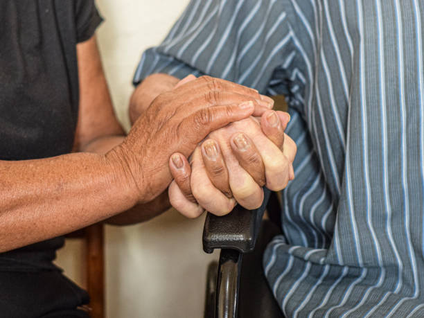 istock Hands of a disabled man being held by his wife 1338907799