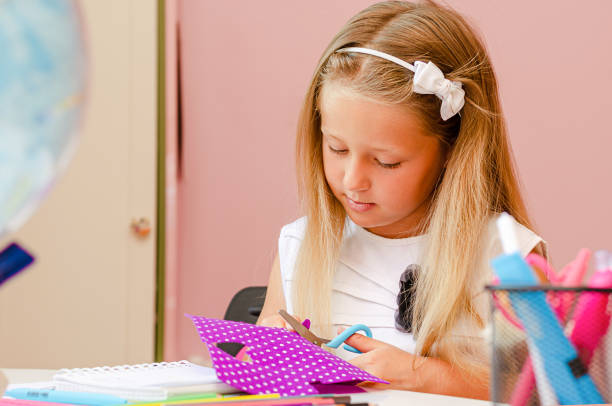 istock Little girl is making crafts from felt. 1338908254