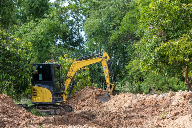 istock The excavator digs a soil. Digger loading trucks with soil. Excavator working on earthmoving at open pit mining. Excavator working on earthmoving at construction site. 1338909340