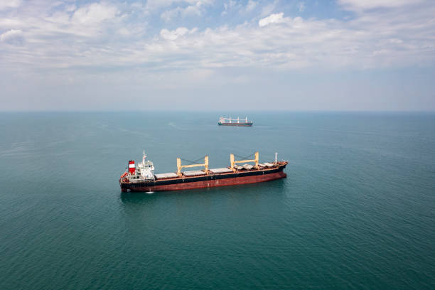 Cargo ship at sea. Cargo ships standing on the roadstead. Import, export and business logistic. International sea transportation concept. Aerial view of Black Sea against Samsun city in Turkey. black sea stock pictures, royalty-free photos & images