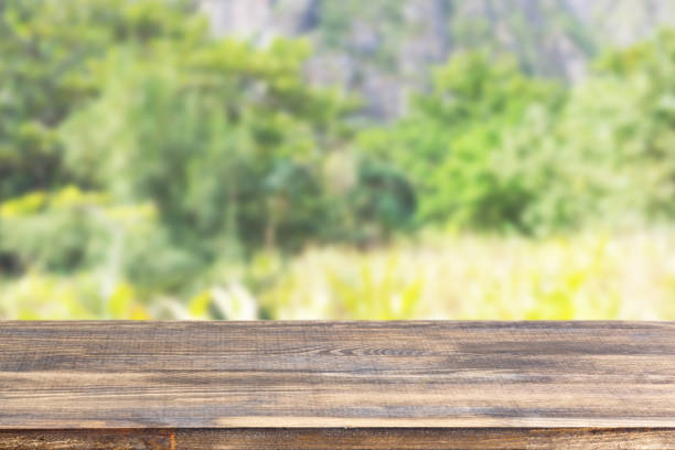 istock wood table top on blur plants and mountains background 1338909689