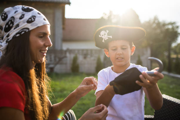 istock A cute boy dressing up as a pirate with his mom 1338910797