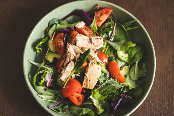 istock Tuna salad in bowl with black fork. 1338910870