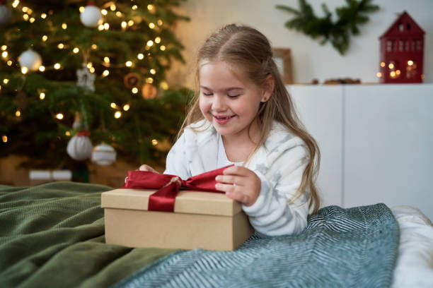 istock Little girl opening the Christmas present 1338911021