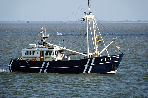 Netherlands. Lauwersoog. August 30. A fishermen boat  on the Wadden Sea