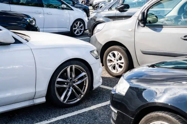 A group of cars parked in marked bays.