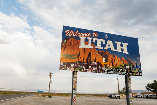 In Baker, United States a Welcome to Utah billboard sign marks the state line by rural highway 50.