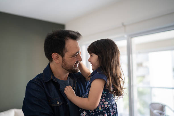 istock Father and daughter embracing at home 1338918053