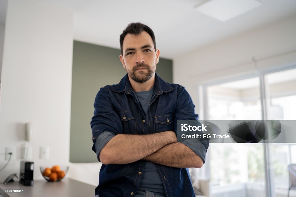 Portrait of a serious man at home Displeased Stock Photo