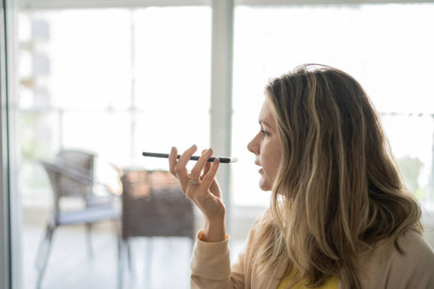istock Woman sending audio message on smartphone at home 1338918098