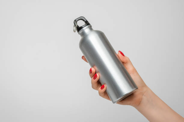 istock Reusable iron water bottle in a woman's hand, red nail polish 1338918178