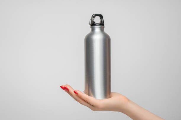 istock Reusable iron water bottle in a woman's hand, red nail polish 1338918187