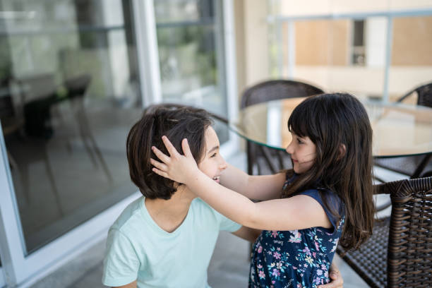 istock Cute siblings together at home 1338918195