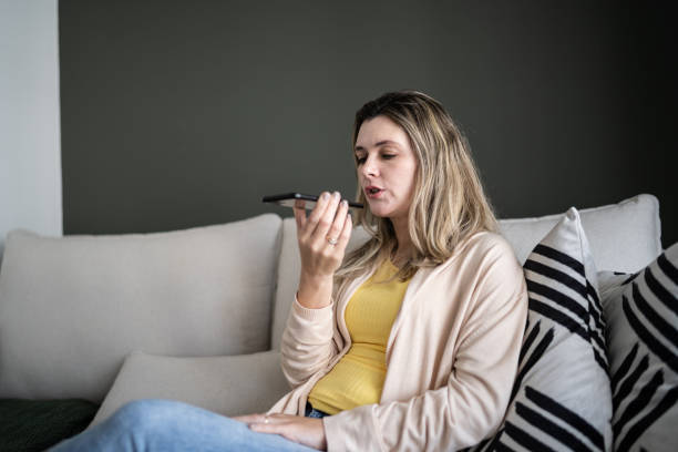 istock Woman sending audio message on smartphone at home 1338918254