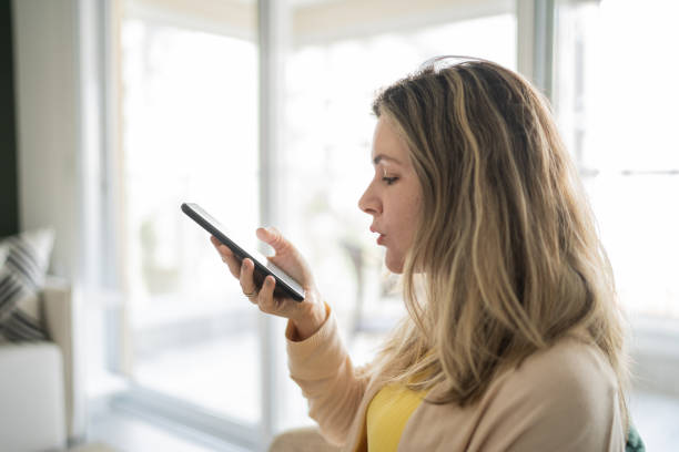 istock Woman sending audio message on smartphone at home 1338918342