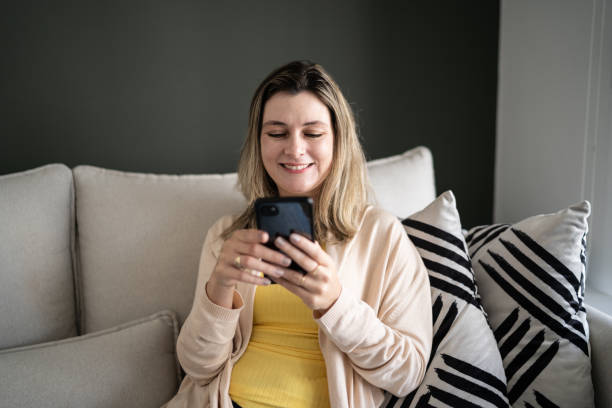 istock Woman using smartphone at home 1338918444