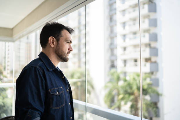 istock Man looking away contemplating at home 1338920920