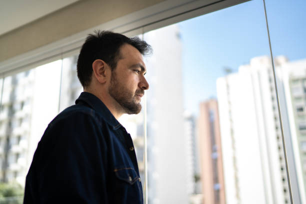 istock Man looking away contemplating at home 1338920942