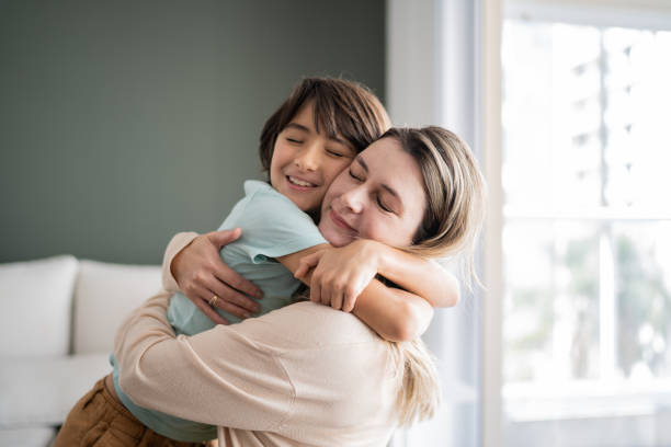istock Mother and son embracing at home 1338920988