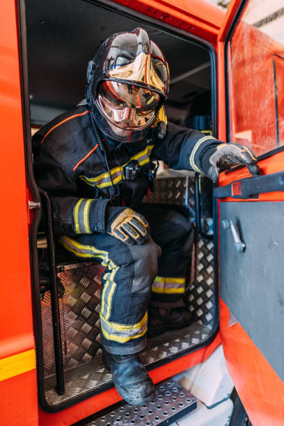 istock Unrecognizable fireman in uniform sitting in fire truck 1338922265