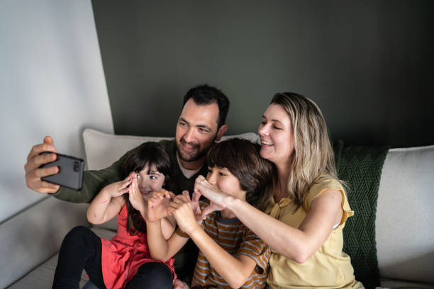 istock Family doing a video call on smartphone at home 1338922475