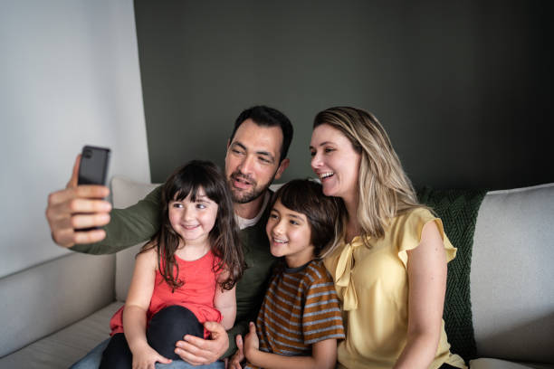 istock Family doing a video call or taking a selfie on smartphone at home 1338922607