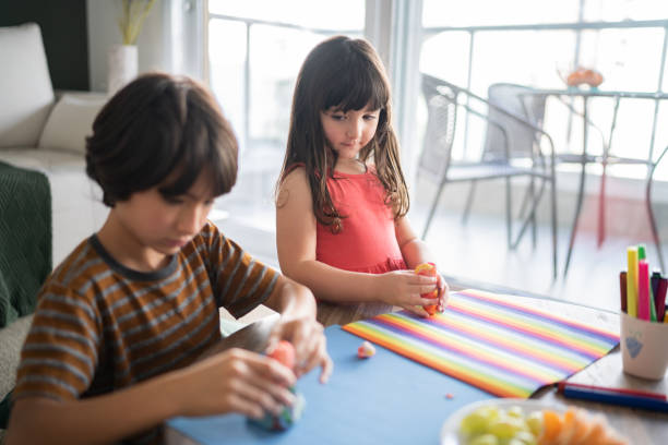 istock Siblings playing with play dough at home 1338922611