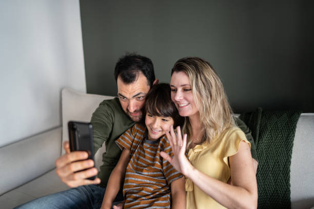 istock Family doing a video call on smartphone at home 1338922612
