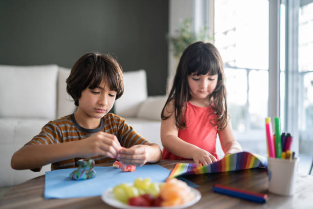 istock Siblings playing with play dough at home 1338922759