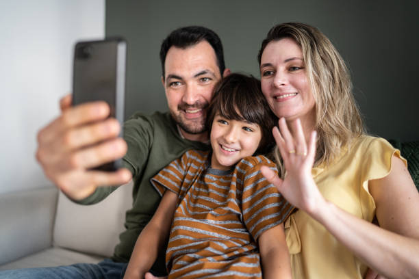 istock Family doing a video call on smartphone at home 1338922841