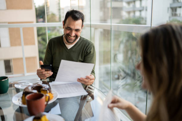 Couple doing home finances during breakfast at home