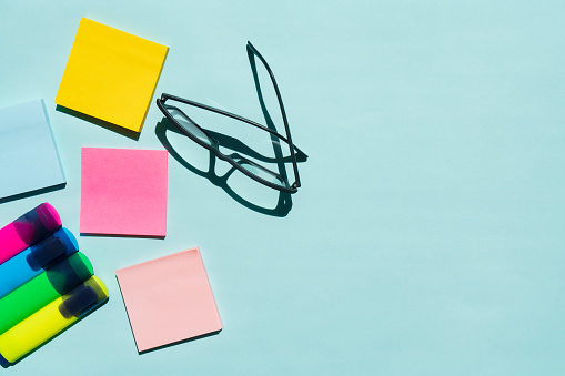 Office Desk with office supplies on colored background