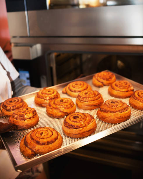 buns from the oven. sweet rolls on a baking sheet. freshly baked puffs. french food. bakery - cinnamon buns people bildbanksfoton och bilder