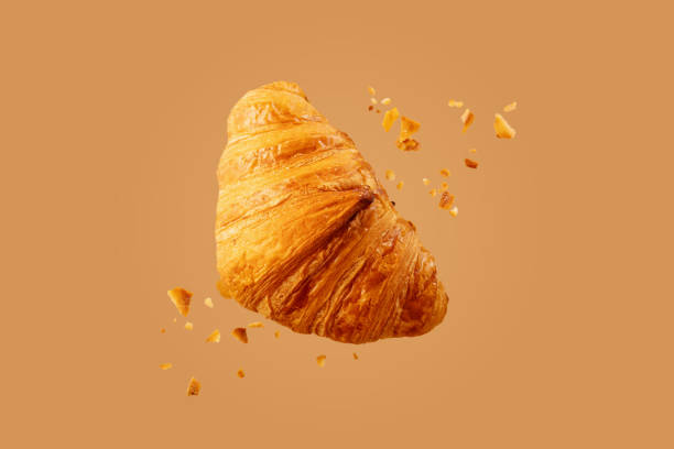 istock Freshly baked croissant flying in air. 1338924641