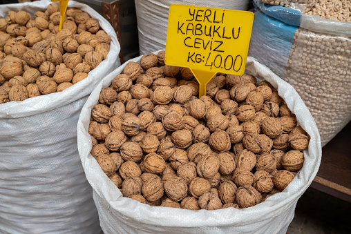 A sack of shelled walnuts with a price tag in the bazaar