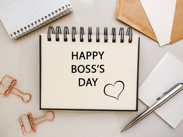 istock Happy Boss Day. Notepad and stationery lying on the table 1338927185
