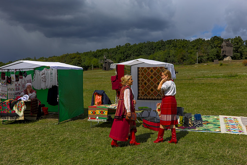 Kyiv, Ukraine - September 5, 2021: Open Air Traditional Crafts Fair. National Ukrainian clothing. Sellers in national costumes during a folk art fair.