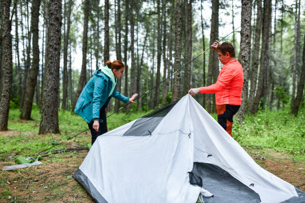 istock Father And Daughter Getting Tent In Order During Camping Trip 1338931415