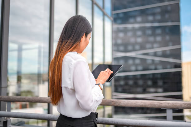 istock Asian Businesswoman Using a Digital Tablet 1338931730