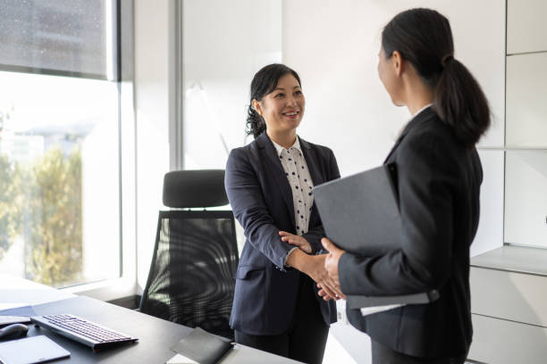 istock Chinese executive greeting her business partner 1338933219
