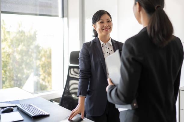 istock Chinese executive greeting her business partner 1338933230