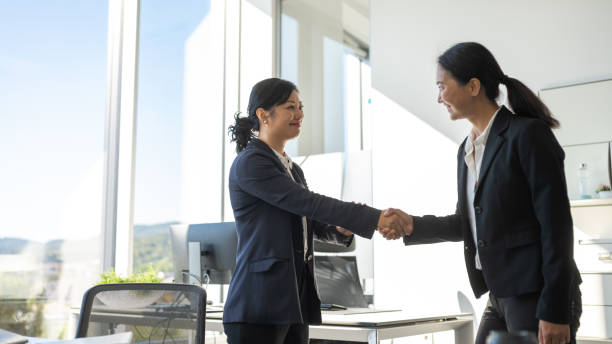 istock Chinese and Japanese female executives shaking hands 1338933232