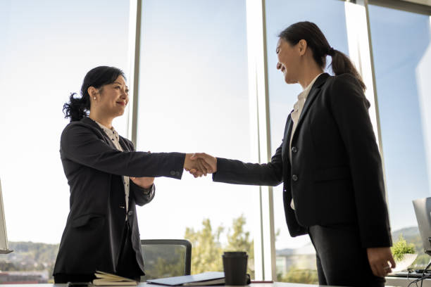 istock Chinese and Japanese female executives shaking hands 1338933239