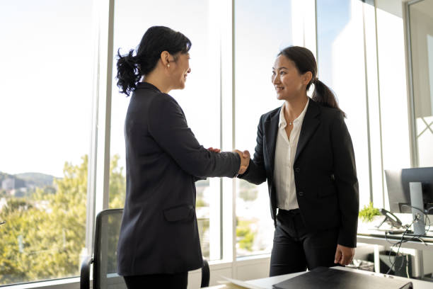 istock Chinese and Japanese female executives shaking hands 1338933241