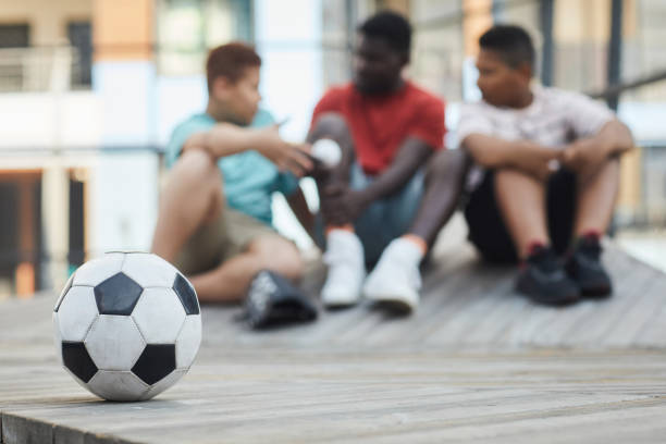 istock Soccer Ball Against Father With Sons 1338935599