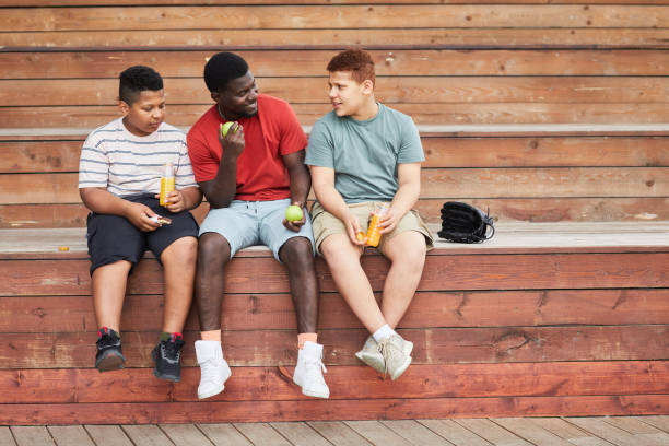 istock Father Sitting With Sons On Bleacher Bench 1338935667