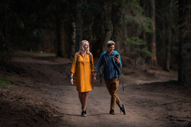 istock A couple of young hikers using a smartphone while they are walking through the woods 1338936585