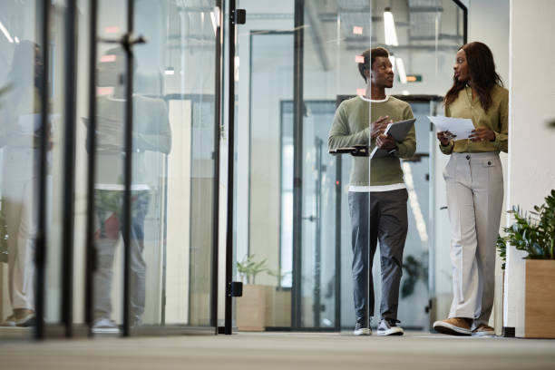 istock Business People Walking Down Office Corridor 1338936644