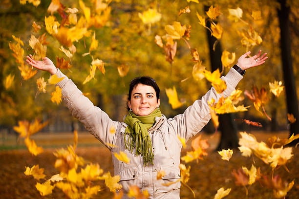 istock Young woman playing with leaves in the park. 133893721