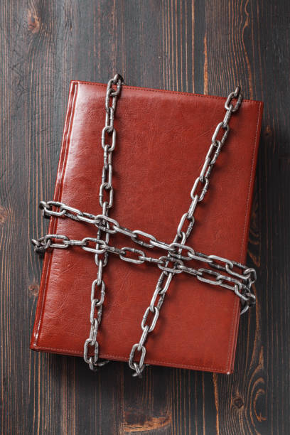 Chained red book on wooden table